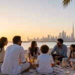 Beach picnic with city skyline at sunset