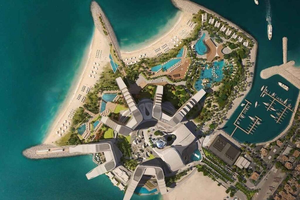 Aerial view of The Island Dubai featuring luxury beachfront resorts, private beaches, swimming pools, landscaped gardens, a marina, and modern waterfront architecture surrounded by the Arabian Gulf.