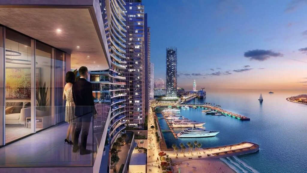 Evening view from an Emaar Beachfront apartment overlooking Dubai Harbour marina, luxury yachts, the beachfront promenade, and the Dubai skyline.