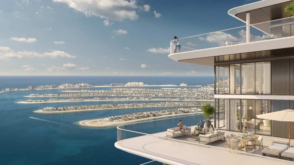 Luxury waterfront apartment balcony at Emaar Beachfront with panoramic views of Palm Jumeirah, the Arabian Gulf, and Dubai's exclusive coastal residences.