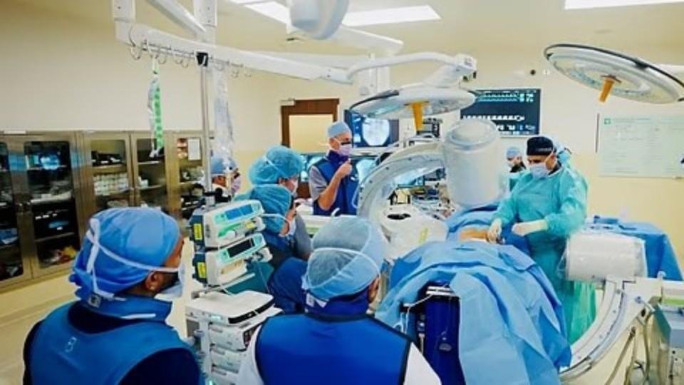 Medical team performing a wireless heart monitor implantation procedure in a cardiac catheterisation laboratory at Cleveland Clinic Abu Dhabi.