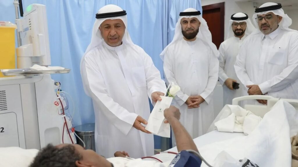Sharjah Charity International representatives visiting a dialysis patient receiving medical aid in the UAE.