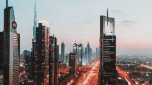 Dubai skyline at dusk with modern skyscrapers, illuminated highways, and a futuristic cityscape representing the growth of Agentic AI, autonomous systems, and intelligent digital innovation.