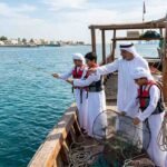 Young Emirati participants practise traditional line fishing and gargoor trap techniques with an instructor during the Al Nokhadha Fishermen Preparation Programme in Sharjah.