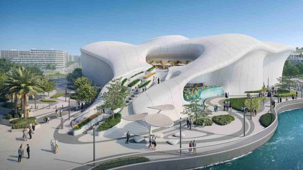 Exterior view of TeamLab Phenomena Abu Dhabi on Saadiyat Island, showing the museum's distinctive white, cloud shaped architecture overlooking the waterfront.