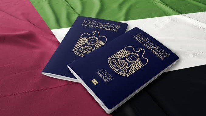 2 UAE passports on UAE flag