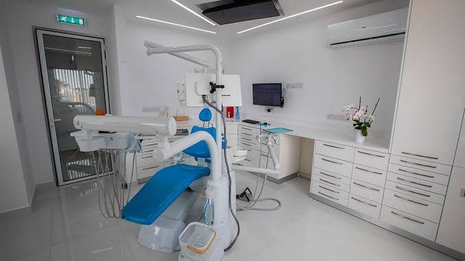 Modern dental clinic in the UAE featuring a dental chair, examination equipment, storage cabinets, bright lighting, and a clean treatment area prepared for patients.