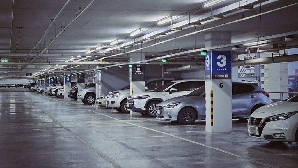 Underground Wafi Mall parking area with multiple cars parked in marked spaces, illuminated overhead lighting, and level 3 parking signs displayed on concrete pillars.